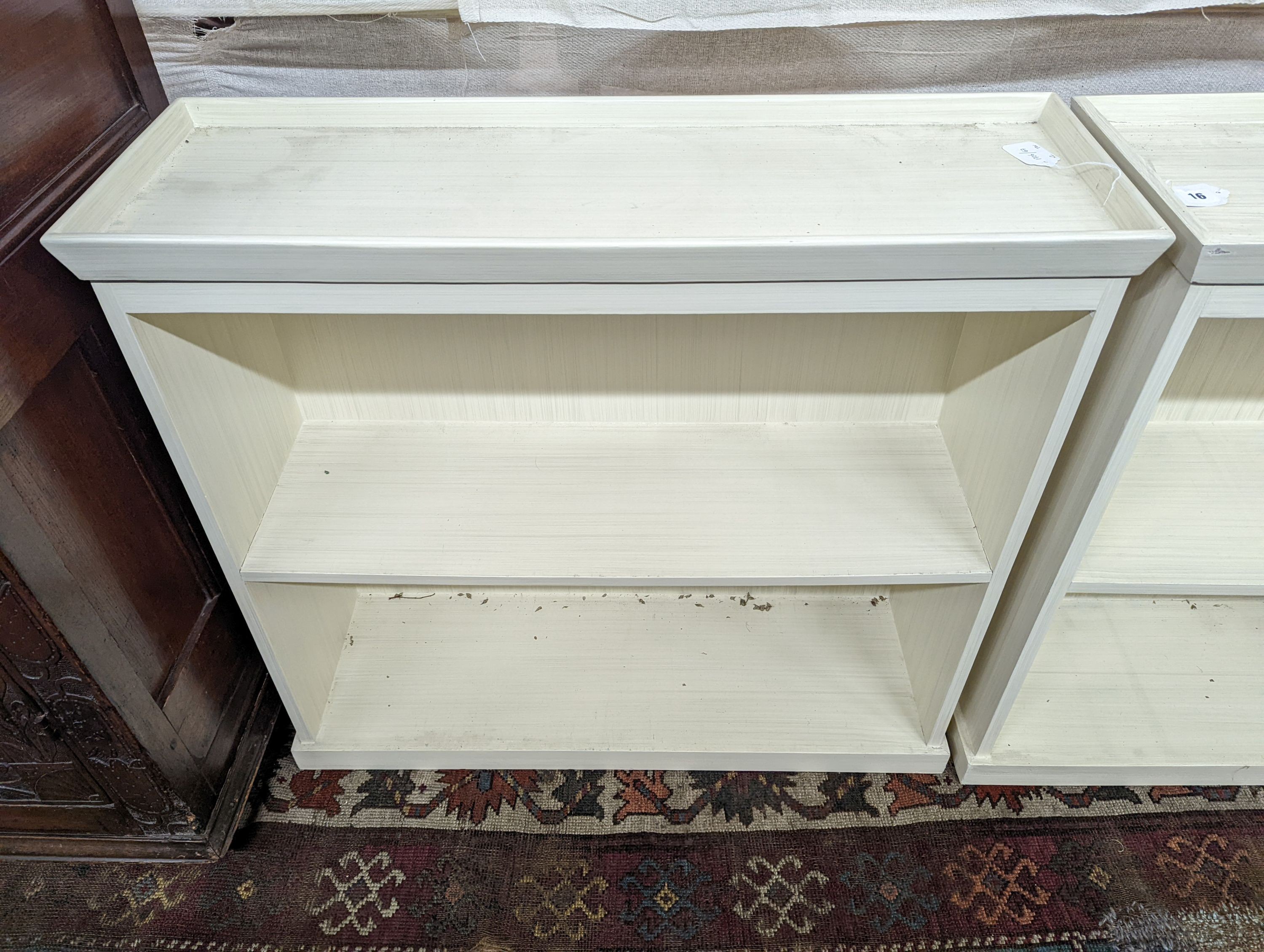 A pair of modern white painted dwarf open bookcases, length 90cm, depth 30cm, height 82cm